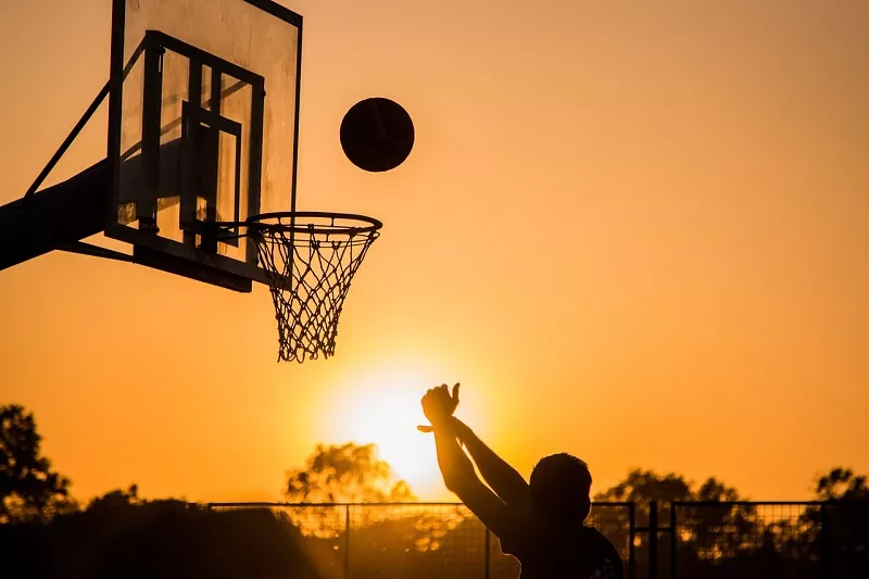 Adult playing basketball